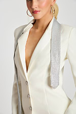 Close-up of white pants showing satin side stripe and smooth fabric texture