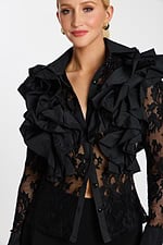 Close-up of sheer floral lace blouse with tiered ruffles and glossy black buttons
