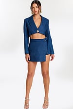 Two-piece denim set with cropped blazer and asymmetrical wrap mini skirt