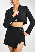 Close-Up of Rhinestone Button Blazer and Asymmetrical Skirt with Metallic Buckle Detail