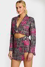 Detail shot of floral tweed fabric and silver buckle on skirt waist