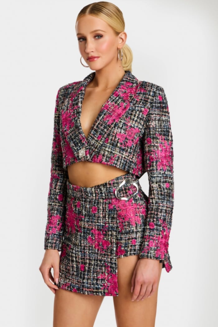 Detail shot of floral tweed fabric and silver buckle on skirt waist