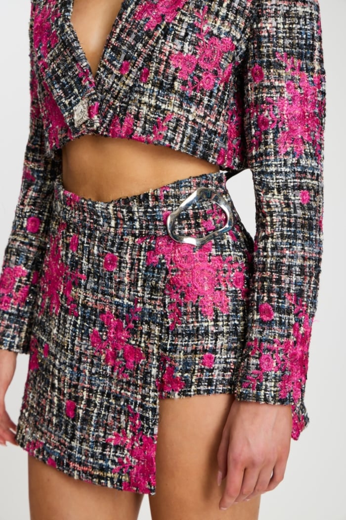 Close-up of model wearing pink and black tweed matching set