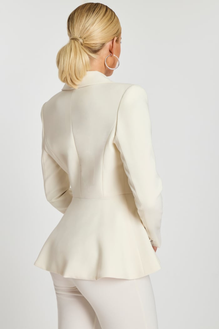 Back view of off-white blazer with fitted waist and soft flared hem