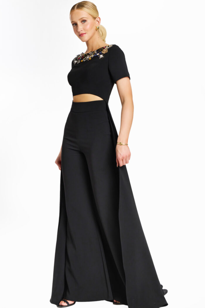 Side view of embellished black pantsuit with short sleeves and cutout waist
