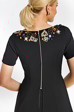 Close-up of rhinestone diamond buttons on white tailored jacket