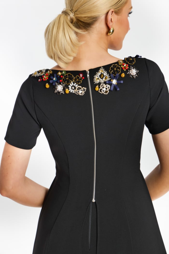 Close-up of rhinestone diamond buttons on white tailored jacket