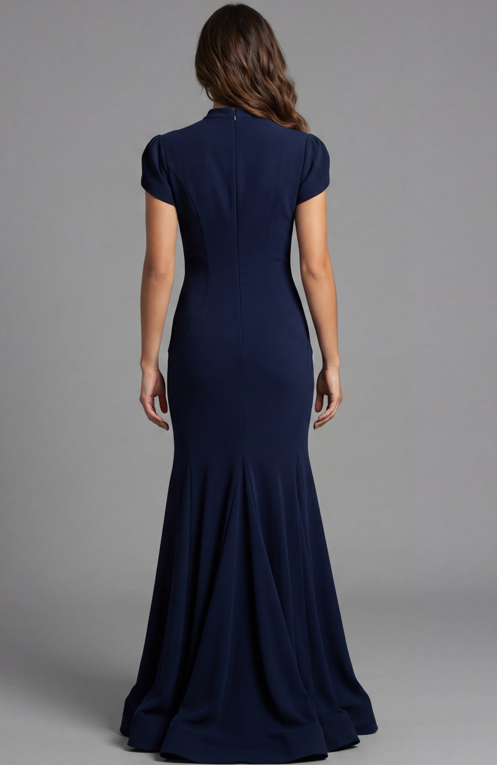 Back view of fitted gown with smooth silhouette and flowing hem