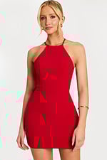 Model facing forward wearing a sleek red halter dress