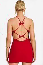 Back view of red mini dress featuring crisscross straps and small bows