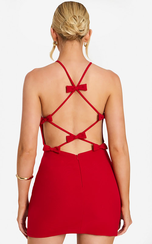 Back view of red mini dress featuring crisscross straps and small bows