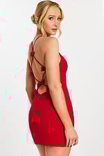Side-back angle showing bow-tied open back design of red mini dress