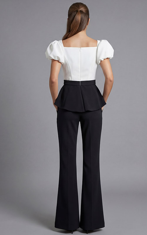 Structured black pants look with white statement sleeves