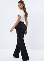 Chic black and white jumpsuit with dramatic peplum detail