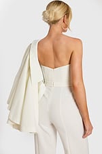 Back angle of cape-style bridal outerwear over tailored jumpsuit