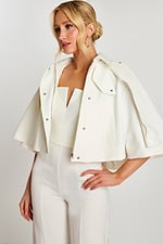 Front view of strapless V-notch white jumpsuit with jacket in hand