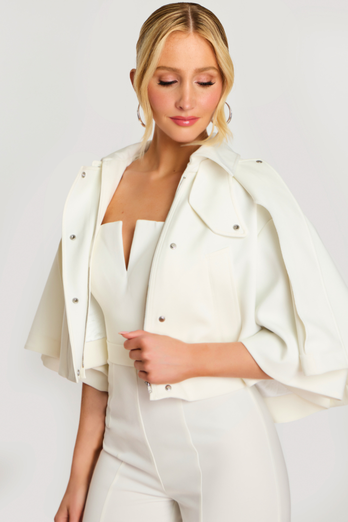 Close-up of bridal white jumpsuit and cape collar with zipper detail