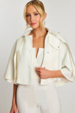 Side close-up showing V-notch neckline and metal zip of bridal cape