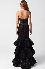 Back view of fitted lace gown with layered ruffles and structured silhouette