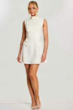 Front view of ivory mini dress with high neck and asymmetrical buttons