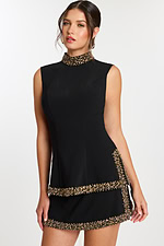 Close-up of black embellished mini dress with high neckline detail