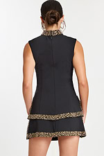 Back view of black mini dress with tiered skirt and beaded trim