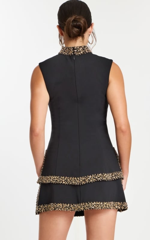 Back view of black mini dress with tiered skirt and beaded trim