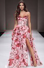 Strapless floral gown with a structured corset bodice, tiered ruffle skirt, and a thigh high slit creating a romantic, flowing silhouette