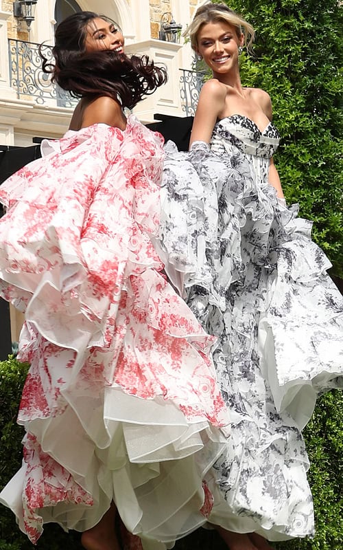 strapless floral ball gown with ruffled skirt - two girls front, dark hair laughing, blonde smiling gloves