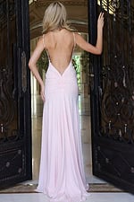 blush fitted rhinestone prom dress with open back - back view, blonde reaching for ornate gate