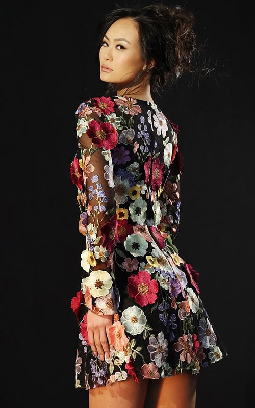 Back view of embroidered floral mini dress with see-through sleeves