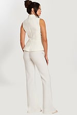 Back view of sleeveless ivory peplum top and wide-leg pants