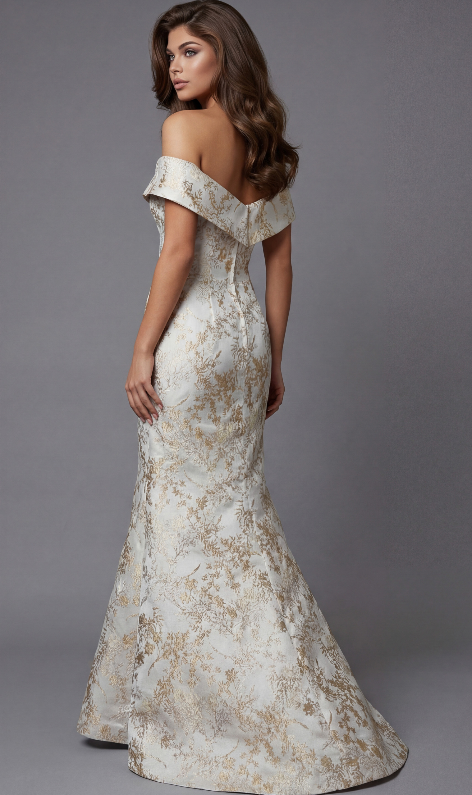 Back view of an off the shoulder evening gown with a fitted silhouette and floor length skirt