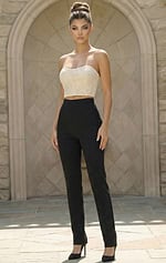 Woman wearing a structured two piece jumpsuit with cropped bodice and tailored pants