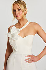 Close-up of ivory one-shoulder jumpsuit with large 3D flower accent