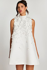 Close-up of high neckline and layered flower details on white satin dress