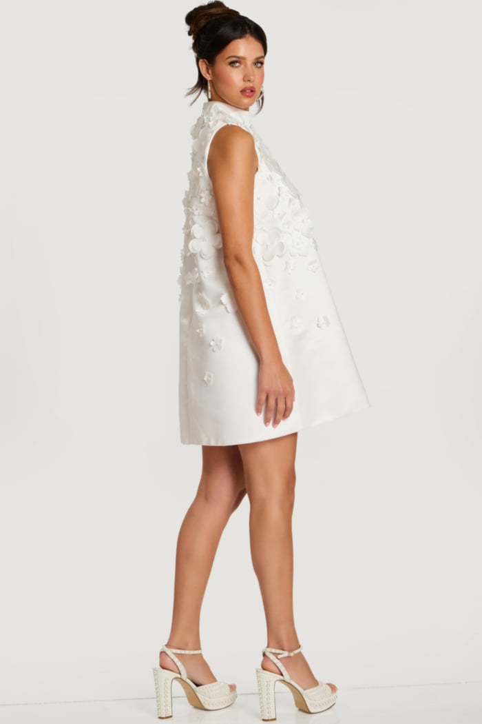 Side profile of floral appliqué dress showing A-line silhouette