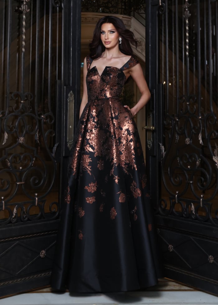Black gown with bronze floral jacquard pattern and V-neckline, indoor front view