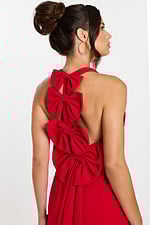 Close-up of triple bow detail on red halter mini dress