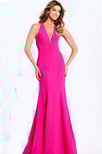 Hot pink halter prom dress with plunging neckline and bow back detail