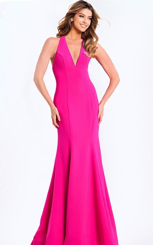 Hot pink halter prom dress with plunging neckline and bow back detail