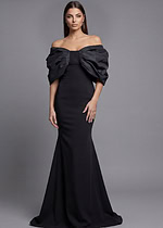 Black off-the-shoulder mermaid evening gown with dramatic puff sleeves and long train, back view.