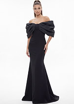 Black off-the-shoulder mermaid gown with dramatic puff sleeves and long train.