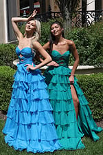 ruffled strapless tiered prom dress - two girls front, blonde hand gesture, brunette high slit