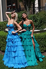 ruffled strapless tiered prom dress - two girls front, blonde hand shielding eyes, brunette showing leg