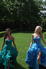 ruffled strapless tiered prom dress - two girls front, blonde dark hair walking grass