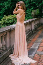 Model seated in Jovani 47780 beige gown with shimmering details