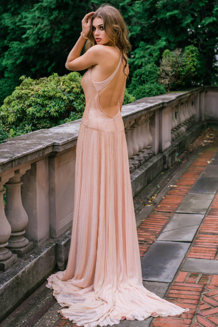 Model seated in Jovani 47780 beige gown with shimmering details