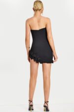 Back view of short black dress with floral trim and zip closure