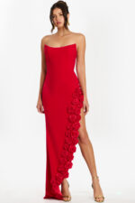Front view of strapless red gown with floral applique trim along high slit